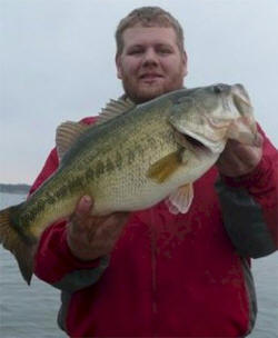 Client with bass caught while fishing with Guide Sam Cotto